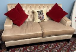 A modern two seater settee upholstered settee with button back upholstery on square tapering legs