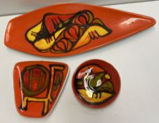 A Poole pottery dish of pointed oval form together with two other smaller examples