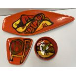 A Poole pottery dish of pointed oval form together with two other smaller examples