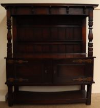An early 20th century oak dresser with a moulded cornice above a plate rack,