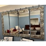 A modern four section wall mirror with a silvered moulded border