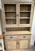 A Victorian pine dresser, the top with two doors and shelves,