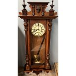 A Victorian walnut Vienna regulator wall clock with a mask cresting, half section columns,