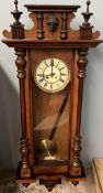 A Victorian walnut Vienna regulator wall clock with a mask cresting, half section columns,