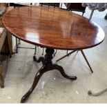 A 19th century mahogany tripod table with a circular top on a bird cage action baluster column and