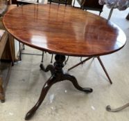 A 19th century mahogany tripod table with a circular top on a bird cage action baluster column and