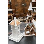 A white painted cottage bird feeder together with a Christmas decoration