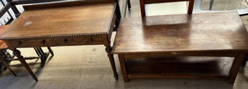 A Victorian style mahogany side table with a raised back and two drawers on tapering legs together
