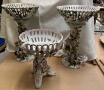 A pair of continental porcelain table centrepieces decorated with figures,