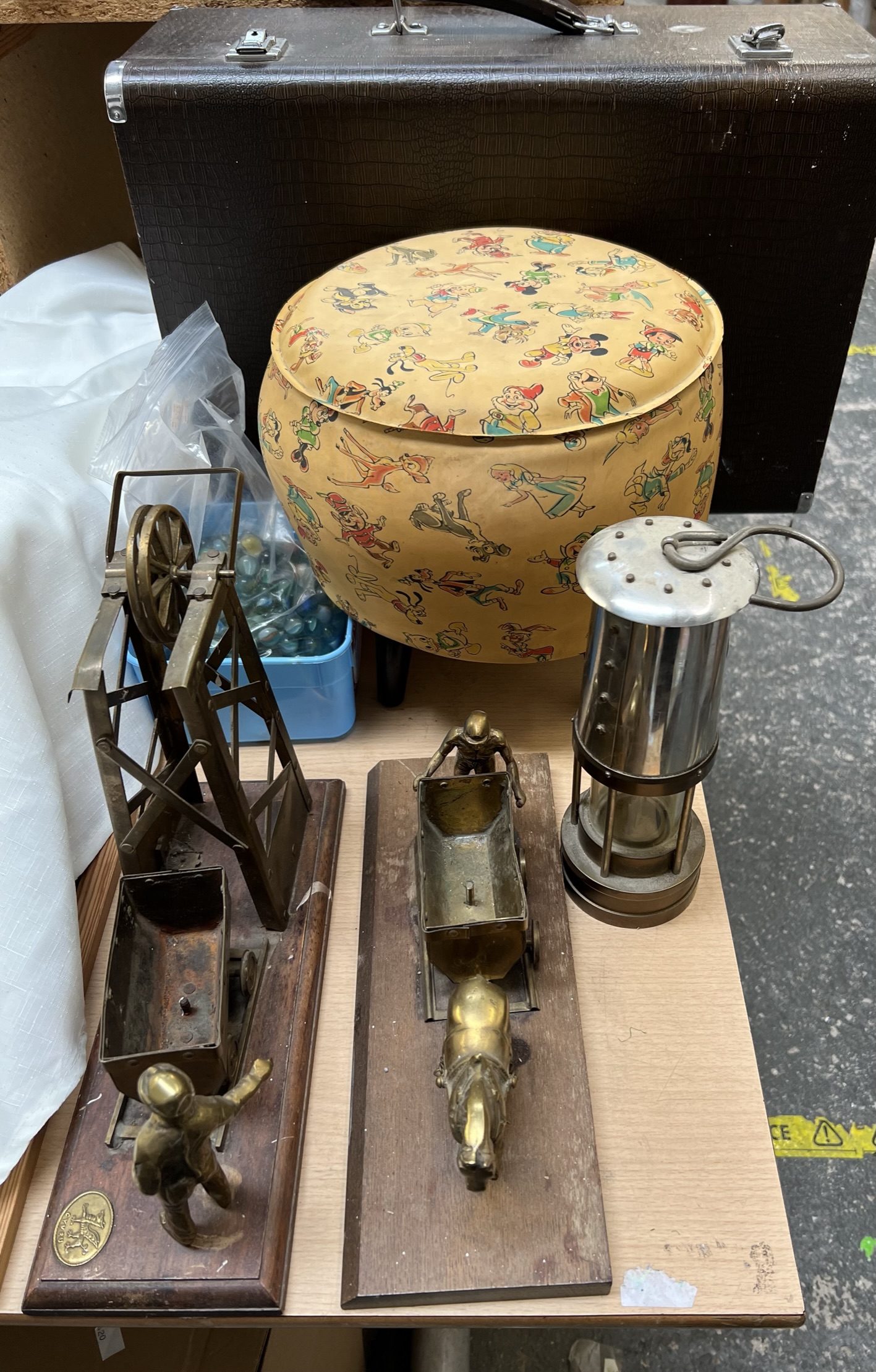 A singer sewing machine together with a puffin stool, marbles,