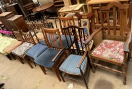 A set of four oak dining chairs with spindle backs together with seven other assorted chairs