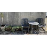 A garden table and two chairs together with three planters