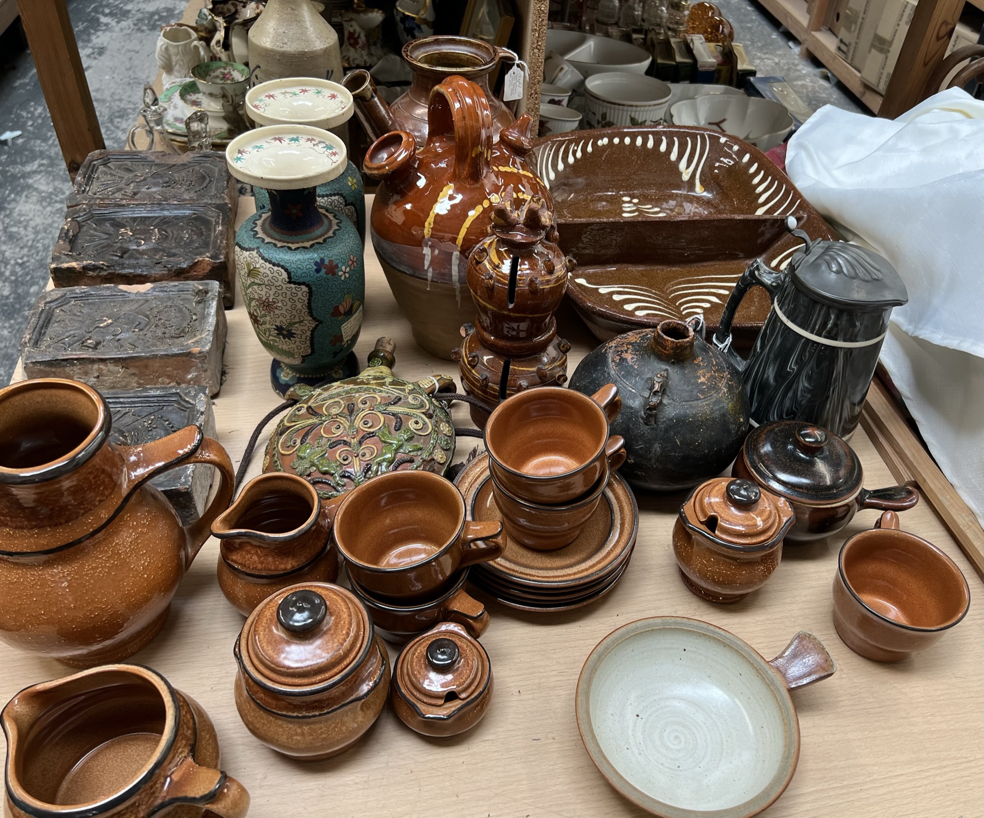 A set of four pottery bricks together with a stoneware bottle dated 1914, a pottery tea set,