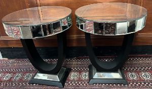 A pair of mirrored side tables of circular form,