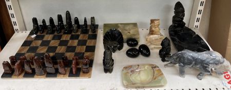 An onyx chess set and board together with a collection on onyx carvings etc