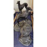 A pair of bronze greyhounds on oval bases together with a bronze falcon on a rocky outcrop