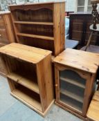 A pine bookcase with shelves and cupboards together with another pine bookcase and a pine HiFi