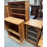 A pine bookcase with shelves and cupboards together with another pine bookcase and a pine HiFi