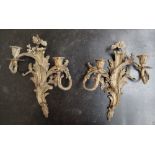 A pair of Rococo influenced ormolu wall sconces,