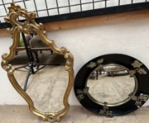 A gilt framed wall mirror with a scrolling leaf surmount together with a convex wall mirror