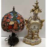 A continental porcelain and gilt metal mounted mantle clock together with a Tiffany style table