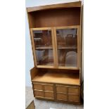 A Nathan teak side cabinet with a pair of glazed doors,
