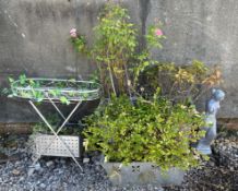 A garden statute together with a set of three metal garden planters and a raised planter