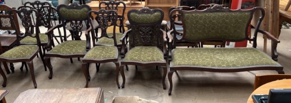 An Edwardian mahogany salon suite comprising a two seater settee,