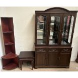 A modern wall unit, with a domed top and three doors with glazed panels and sides,