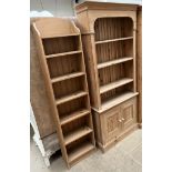 A pine bookcase with a moulded cornice above three shelves,