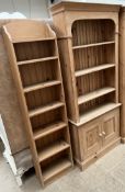 A pine bookcase with a moulded cornice above three shelves,