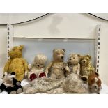 A collection teddy bears together with pyjama cases etc