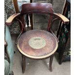 A bentwood elbow chair with a circular seat together with a brass calendar for 200 years 1963 to