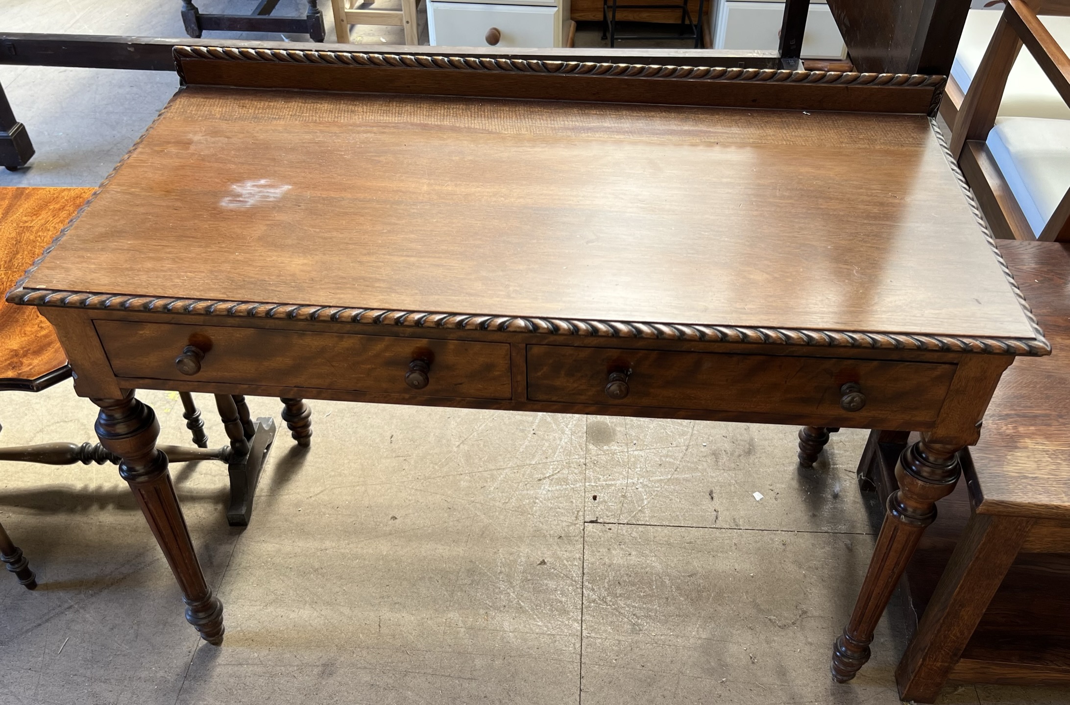 A Victorian style mahogany side table with a raised back and two drawers on tapering legs together - Bild 2 aus 3