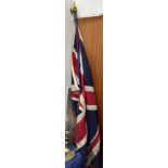 A large Union Flag on a painted pole