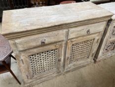 A limed side cabinet with a rectangular top above a pair of frieze drawers and a pair of pierced