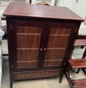 A hardwood and bamboo television cabinet with two cupboard doors and a base drawers on square