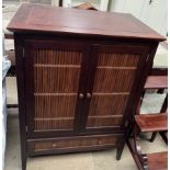 A hardwood and bamboo television cabinet with two cupboard doors and a base drawers on square