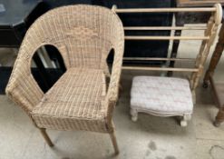 A wicker elbow chair together with a towel rail and an upholstered footstool