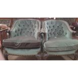 A pair of Edwardian mahogany tub chairs with button back upholstery and pad seats on leaf carved