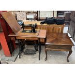 An oak cased singer sewing machine table with treadle base together with a mahogany coffee table of