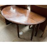 A mahogany gateleg dining table with drop flaps on ring turned legs and casters