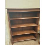 A 20th century oak bookcase with a moulded cornice above four shelves and square legs