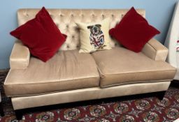 A modern two seater upholstered settee with button back upholstery on square tapering legs