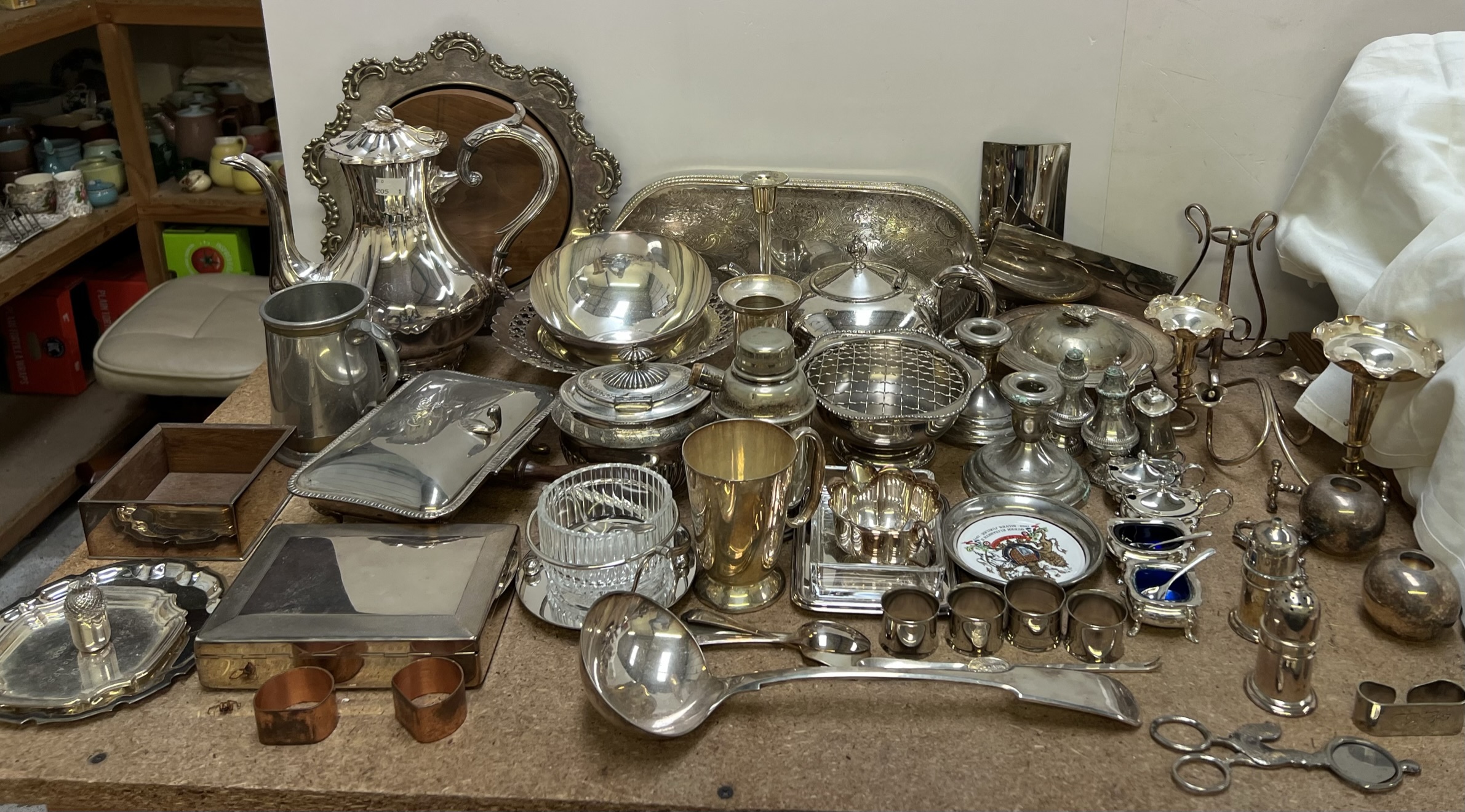 A large assortment of electroplated wares including an epergne, sugar box and cover, cruets,