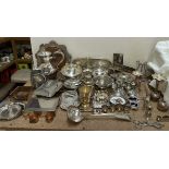 A large assortment of electroplated wares including an epergne, sugar box and cover, cruets,