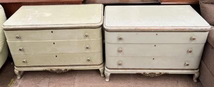 A pair of green painted chests of drawers each with three drawers on cabriole legs each