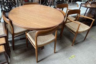 A mid 20th century teak extending dining table with two additional leaves together with a set of