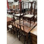 A 20th century extending dining table together with a set of eight Queen Anne style dining chairs