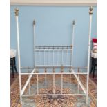 A white painted brass and iron double bed